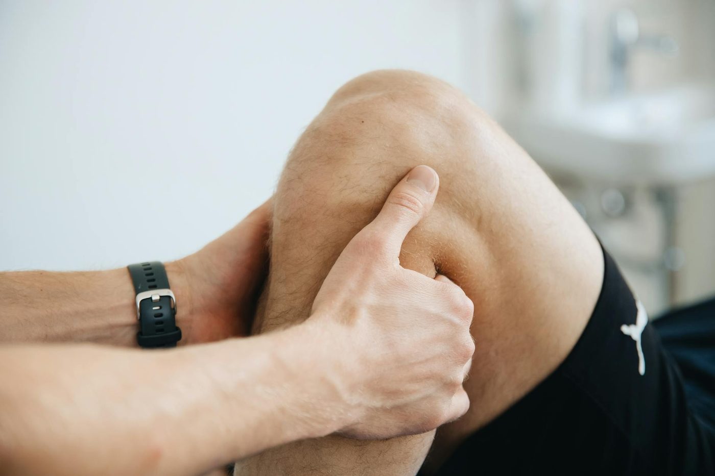 Physiotherapist working on knee and leg support
