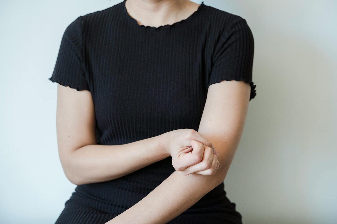 Person holding the arm near the elbow